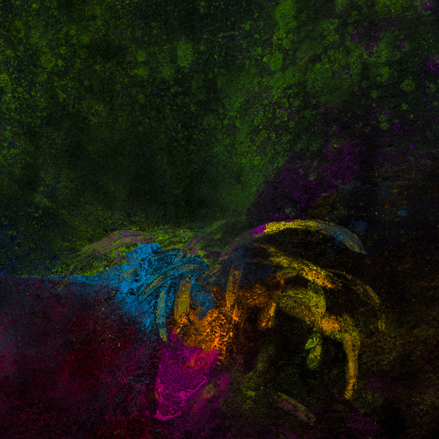 Free: Bright rangoli colors spread over black surface 
