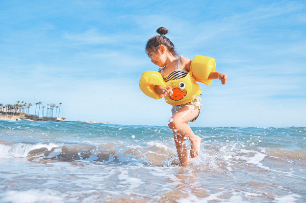 kid,child,young,girl,playing,fun,happy,smile,smiling,laughing,beach,sand,water,ocean,sea,blue,sky,summer,sunshine,floaties,swimming
