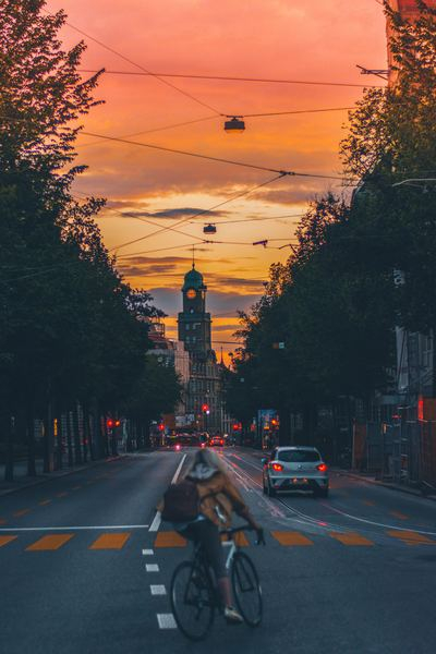 world,sunset,outdoor,mmmmm,woman,girl,street photography,street,city,cyclist,road,building,sky,car,travel,transport,perspective,tower,light,cable,city,free stock photos