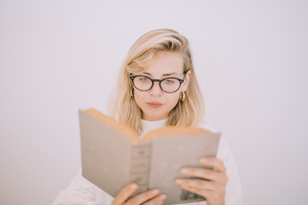 seriously,indoors,closeup,blond,eyeglass,novel,isolated,spectacle,eyewear,casual,adult,holding,studying,woman hair,read,lifestyle,portrait,holding hands,background white,education background,young,learn,female,knowledge,studio,lady,open,reading,open book,learning,person,backdrop,white,human,study,white background,student,home,hair,woman,education,hand,house,book,people,background