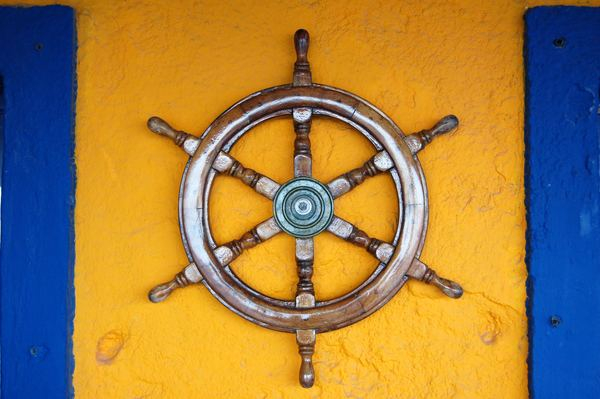 arn,spark,ship,colour,rock,old,object,wood,blue,wheel,wall,concrete,yellow,blue,ship,steering wheel,boat,nautical,wooden wheel,cromatic,chromatic,creative commons images