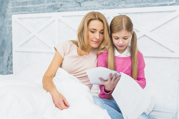 looking down,indoors,adorable,blond,little,daughter,casual,two,leisure,looking,smiling,pretty,horizontal,parent,adult,down,holding,blanket,papers,sheet,beauty woman,cute girl,lifestyle,sitting,beautiful,together,female,reading,bed,learning,drawing,white,clothes,room,child,mother,kid,cute,home,pink,girl,woman,family,house