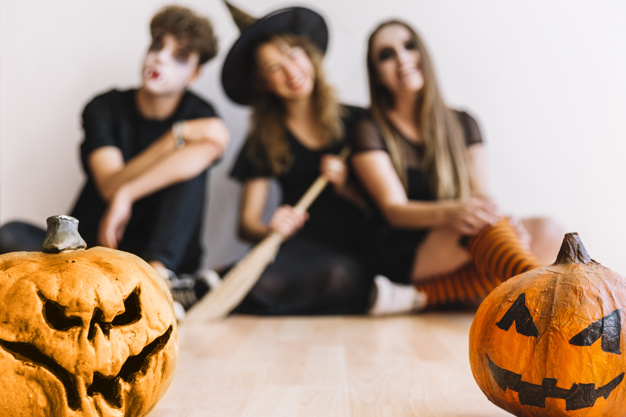 party,halloween,autumn,space,celebration,orange,black,decoration,fall,teenager,young,witch,masquerade,sitting,focus,season,halloween party,bat,broom,soft