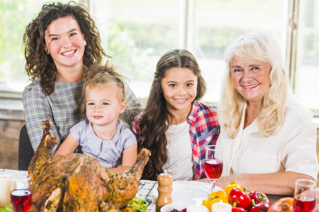 food,children,family,camera,thanksgiving,table,home,fruit,chicken,celebration,holiday,mother,child,drink,candle,plate,vegetable,dinner,lady