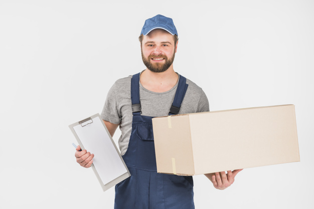 looking at camera,studio shot,overall,brunette,cheerful,casual,handsome,friendly,standing,looking,big,smiling,occupation,horizontal,parcel,shot,adult,holding,courier,carton,delivery man,male,positive,clipboard,paper background,cardboard,packaging box,holding hands,background white,professional,uniform,young,light background,studio,cap,package,service,background blue,beard,worker,job,person,pen,white,clothes,happy,white background,delivery,blue,box,man,camera,light,paper,hand,blue background,background