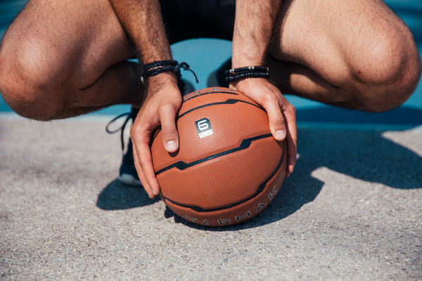 adult,athletic,bright,fit,floor,game,outdoors,player,sport,ballgame,basketball,braided bracelets,competition,court,day,daylight,ground,healthy,knees,legs,leisure,one,palms,person,play,shadow,sitting on toes,wrist,youth
