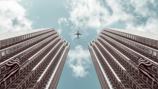 aeroplane,airplane,american,American flags,architecture,blue sky,building,buildings,city,composition,daytime,glass windows,high rise,modern,office,offices,outdoors,skyline,skyscraper,tall,tower,travel,urban,worm&#39;s-eye view,Free Stock Photo