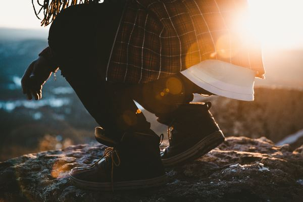 fashion,lifestyle,woman,outdoor,sunset,travel,outdoor,adventure,travel,shoe,boot,plaid,crouch,crouching,sunset,sunrise,rock,dreadlocks,laces,adventure,outdoor