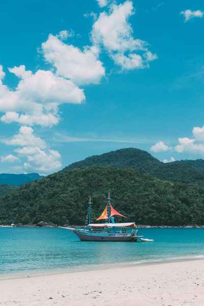 water,vacation,turquoise,tropical,travel,tranquil,summer,sky,ship,seashore,seascape,sea,scenic,scenery,sand,sailboat,relaxation,paradise,ocean,nature,mountain,landscape,island,idyllic,exotic,clouds,cliff,boat,beach,bay