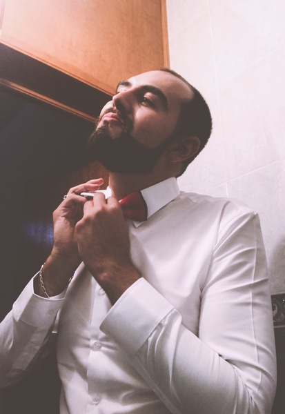 wear,pose,photoshoot,person,outfit,man,looking,indoors,hands,guy,full beard,formal,fine-looking,fashion,facial expression,face,confidence,close-up,bow tie,beard,adult