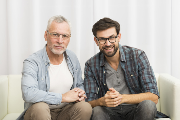 background,hand,camera,man,hands,home,smile,white background,happy,room,white,father,sofa,cloth,together,young,background white,sitting,elderly,eyeglasses,positive,male,senior,guy,parent,horizontal,smiling,looking,wear,casual,son,cheerful,accessory,aged,joyful,settee,indoors,at,fatherhood,toothy,looking at camera,clasping,multigenerational,toothy smile