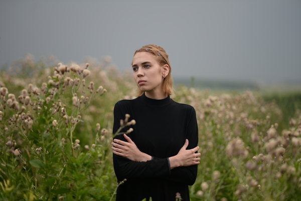 alone,black dress,countryside,facial expression,fashion,field,flora,flowers,grass,hayfield,landscape,lonely,model,nature,outdoors,park,person,portrait,sad,woman