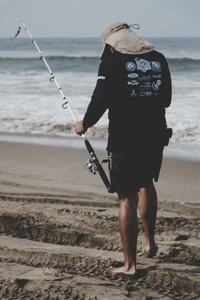 Free: Man in Black Long-sleeved Top Holding White Fishing Rod Near