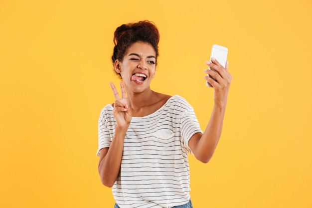 Free: Funny african lady grimacing and making selfie on phone isolated Free  Photo 
