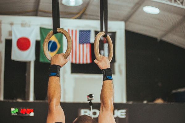 action,active,athlete,energy,exercise,exercise equipment,flags,gym,gymnast,gymnastics,hands,indoors,man,muscles,person,rings,sport,sports equipment,stadium,strength,wear,Free Stock Photo