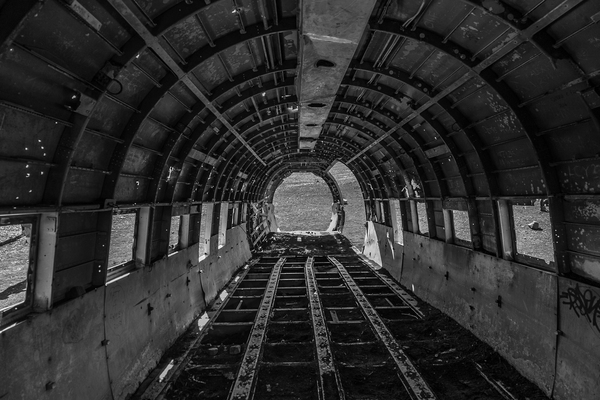 abandoned,aircraft,black and white,daylight,empty,environment,indoors,inside,scenic,steel,wreck
