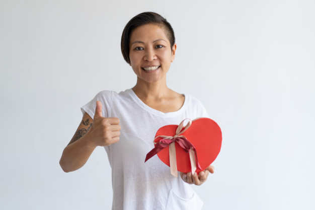 shaped,showing,posing,preparation,casual,front,saint,standing,short,looking,smiling,horizontal,adult,holding,positive,greeting,thumb,day,woman hair,up,portrait,view,asian,heart shape,boxing day,young,dark,gift ribbon,female,valentines,surprise,thumbs up,womens day,studio,customer,lady,tshirt,happy holidays,present,person,event,gift card,holiday,bow,happy,anniversary,gift box,hair,box,camera,woman,gift,heart,happy birthday,birthday,ribbon