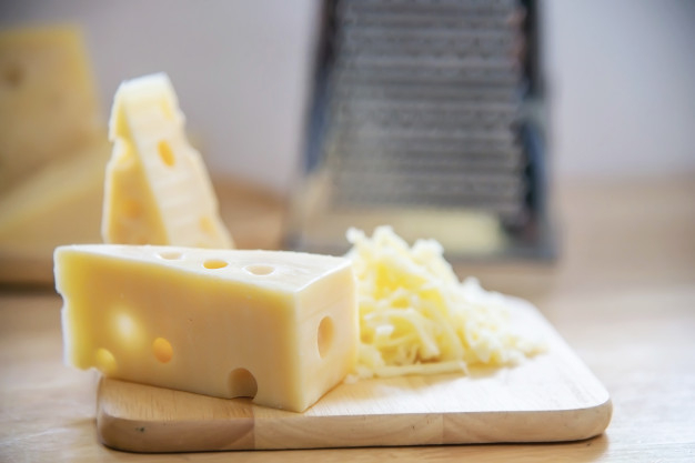 Cheese Beeing Grated In The Kitchen Stock Photo - Download Image