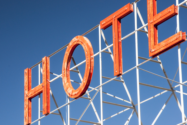 hotel,sign,letters,orange,blue,sky
