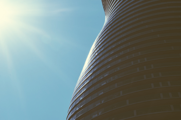tower,tall,sun flare,structure,steel,sky,outdoors,modern,lines,futuristic,exterior,design,curvy,curves,building,blue sky,architecture,architectural design