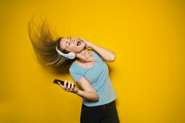 25-30 years,beautiful,dance,dancing,denim,funny,girl,lady,laughing,music,old,yellow,young,black jeans,blue t-shirt,caucasian,cellphone,device,earphone,electronics,face facial expression,female,hair,headphone,isolated on yellow background,mobile,mobile phone,model,motion,person,phone,photo shoot,smartphone,sound,technology wear,wireless,woman,yellow background
