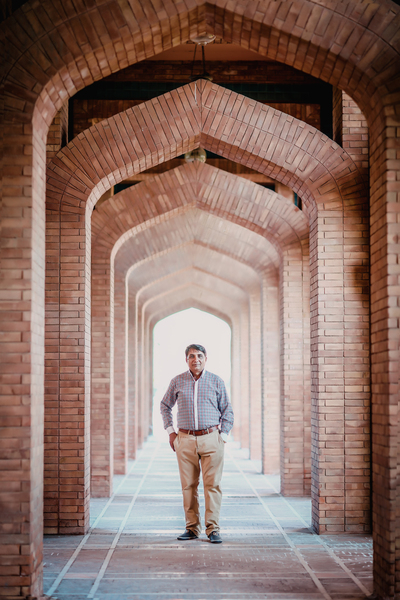 adult,alley,ancient,arch,arches,architecture,bricks,building,entrance,facade,hallway,indoors,man,old age,outdoors,standing,stone,urban