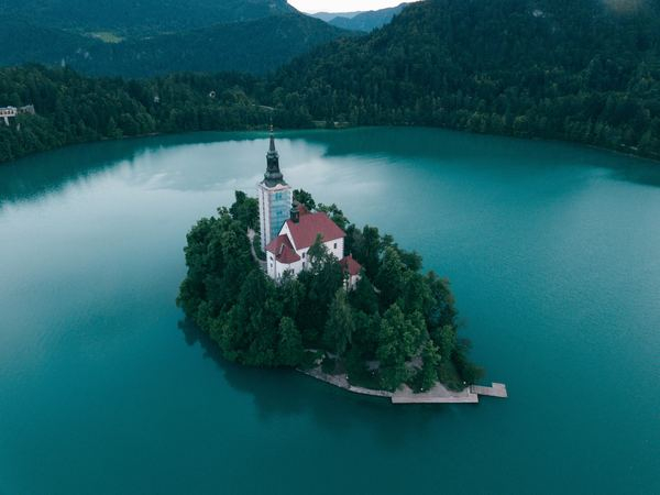 cloud,forest,sunrise,castle,architecture,building,architecture,bridge,building,island,lake,forest,tree,castle,building,spire,mountain,remote,bled,green,blue,free stock photos