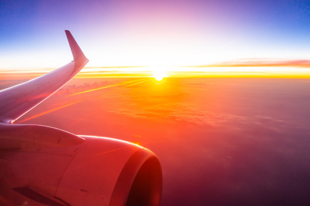 panoramic,aerial,atmosphere,high,looking,airline,horizon,aviation,aeroplane,beautiful,view,aircraft,flight,air,sunrise,transportation,fly,vacation,sunset,wing,transport,window,white,time,plane,airplane,sky,sun,blue,nature,cloud,travel