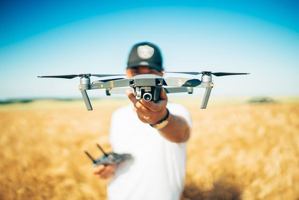 urban,city,building,technology,working,business,prasi,blue,computer,drone,person,caucasian,camera,photographer,remote control,field,meadow,grass,sky,blue,outdoor,free stock photos