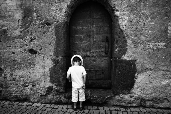 wall,street,stone,kid,door,child,building,black-and-white