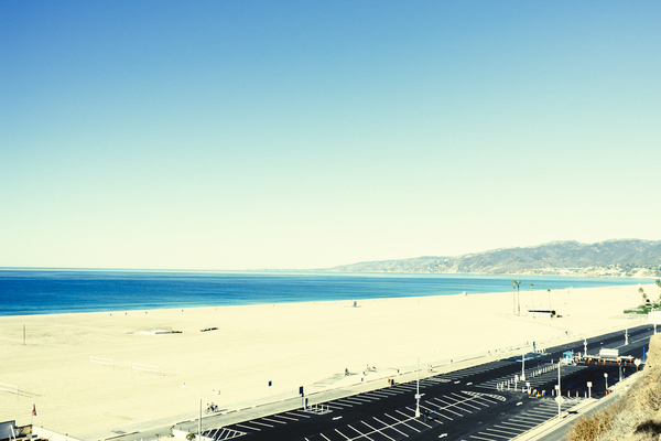 beach,sand,water,ocean,blue,sky,sunshine,boardwalk,parking lot,mountains,view