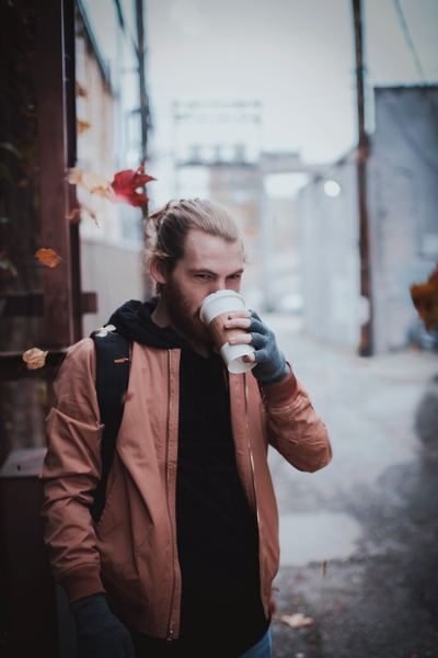 person,woman,girl,jutka55,portrait,man,leafe,autum,leaves falling,man,male,holding,coffee,cup,drink,falling leaves,drinking,hand,standing,jacket,leaves