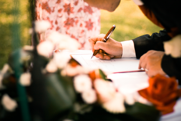 writing,table,signing,pen,marriage,man,flowers,depth of field,contract