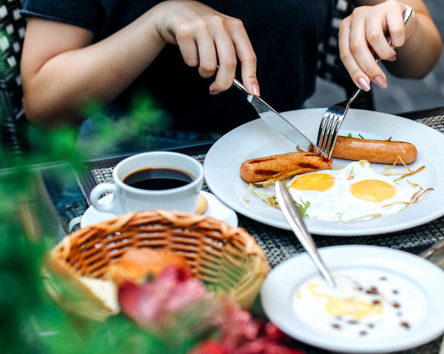 american,eggs,1,eating,morning,breakfast,cup,juice,person,orange,table,coffee,food