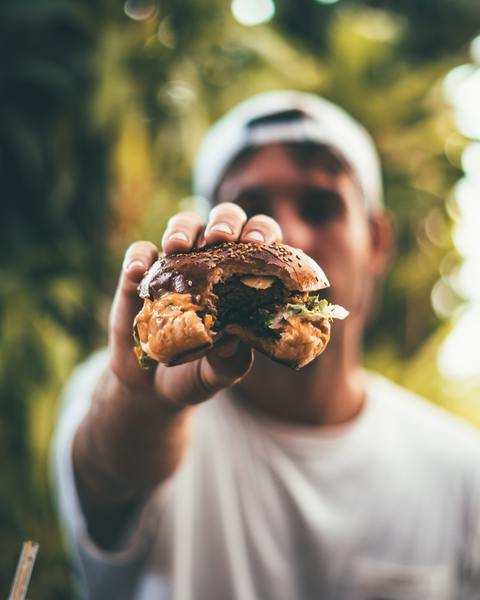 man,eating,burger,hamburger,tasty,food,cap,hat,white,travel
