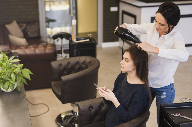 Free: Brunette girl getting her hair done 