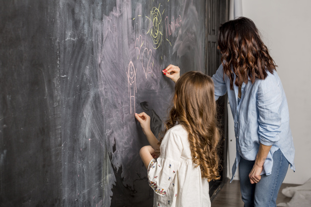copy space,indoors,side view,brunette,little,daughter,small,side,casual,standing,copy,horizontal,parent,adult,holding,lovely,lifestyle,bright,beautiful,view,dark,together,female,sweet,drawing,creative,chalkboard,room,child,mother,shirt,colorful,kid,wall,cute,space,blackboard,home,girl,light,woman,family,house,love
