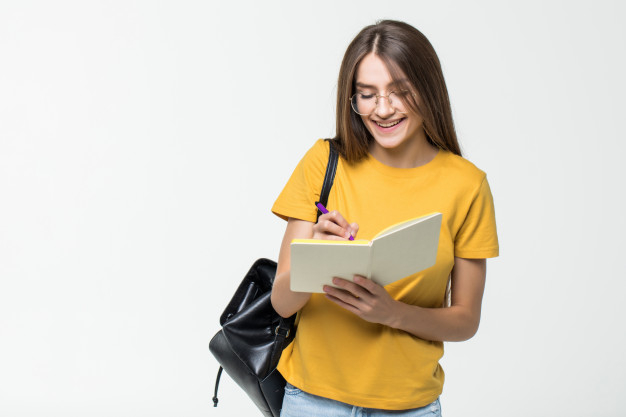 Free: Portrait of a smiling casual girl student with backpack writing ...