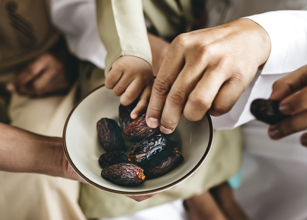 bowl,close-up,delicious,dried dates,dry,fruits,hands,indoors,people,picking,raw,ripped,sharing,tasty,together