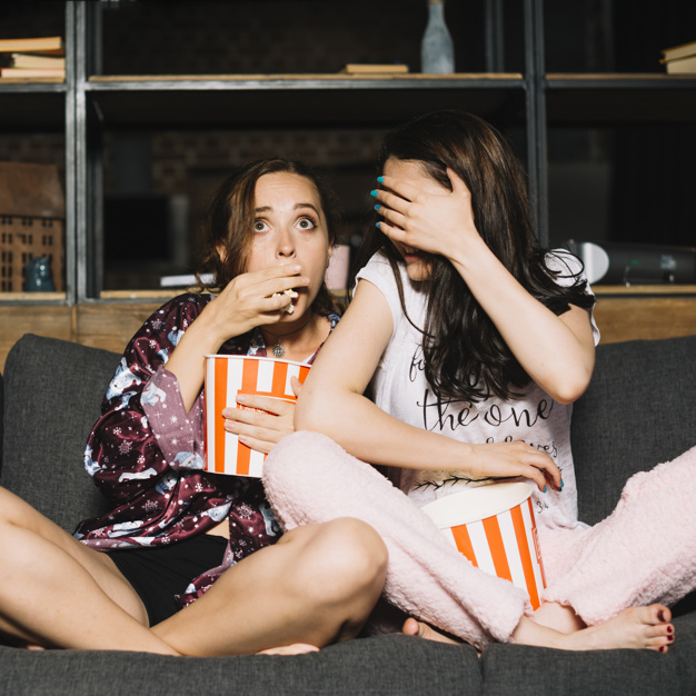 people,cover,hand,woman,film,room,tv,movie,friends,eyes,modern,interior,media,living room,sofa,toy,model,popcorn,television,eating,female,young,horror,entertainment,beautiful,expression,portrait,lifestyle,beauty woman,bucket,couch,leg,scary,sit,facial,fear,adult,living,leisure,two,scared,watching,casual,emotional,full,afraid,serious,brunette,length,crossed,stare,while,indoors,gaze,terrified,full length