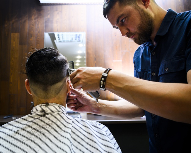 Man Getting His Hair Cut at a Barber Shop · Free Stock Photo