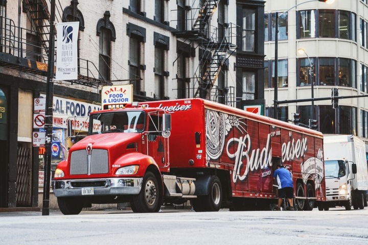 alcoholic beverage,alcoholic drink,beer,budweiser,buildings,business,cargo,city,commerce,delivery,lorry,parked,street,supply,transportation,transportation system,truck,unloading,urban,vehicle