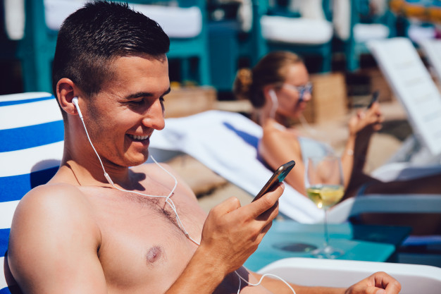 music,summer,phone,man,beach,happy,holiday,smartphone,happy holidays,vacation,headphones,relax,young,summer beach,lifestyle,cell,headset,cell phone,listen,guy