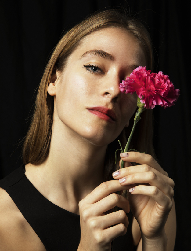 looking at camera,studio shot,pensive,thoughtful,posing,blond,sensual,bloom,dreaming,carnation,stem,standing,looking,calm,pretty,shot,adult,holding,petal,season,bright,portrait,beautiful,blossom,fresh,young,dark,female,romantic,studio,lady,model,natural,plant,person,colorful,black,spring,face,cute,black background,hair,pink,camera,green,woman,summer,floral,flower,background