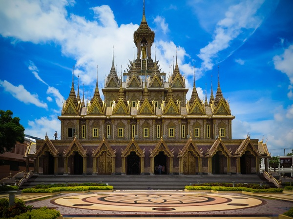 worship,thailand,temple,outdoors,landmark,golden,gold,exterior,clouds,castle,building,architecture,ancient