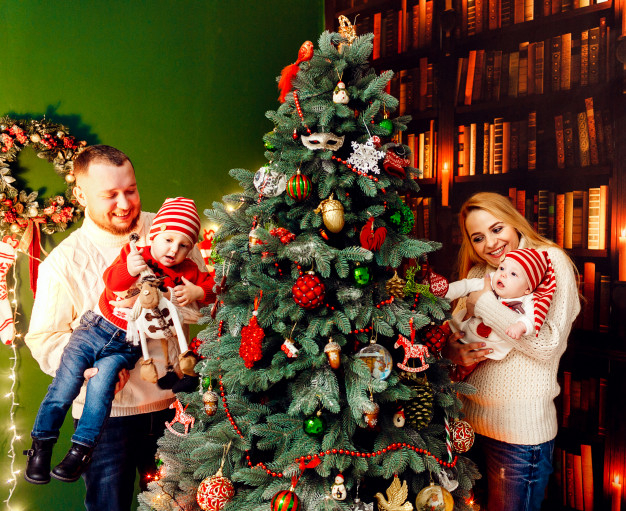 Portrait of parents and two children sitting in front of xmas tree, Stock  Photo, Picture And Royalty Free Image. Pic. ISO-IS09AN3UG | agefotostock