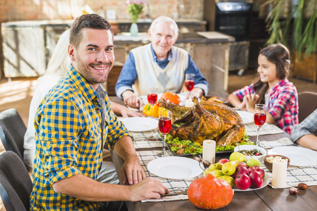 food,family,camera,man,thanksgiving,table,home,chicken,celebration,holiday,child,couple,drink,candle,plate,vegetable,dinner,father