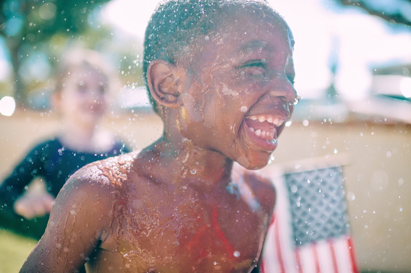 kids,child,boy,happy,smile,smiling,laughing,people,children,usa,flag,water,sprinkler,black,african american