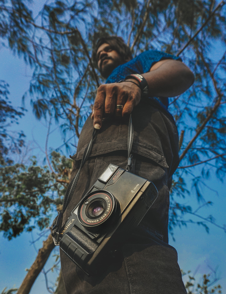 camera,close-up,daytime,equipment,instrument,lens,man,outdoors,person,technology,tree,wear,royalty free images