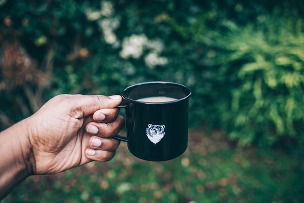 man,black,male,cafe,hand,drink,outdoor,outside,forest,cup,mug,holding,hand,cup of tea,coffee mug,black,tea,bokeh,beverage,container,coffee
